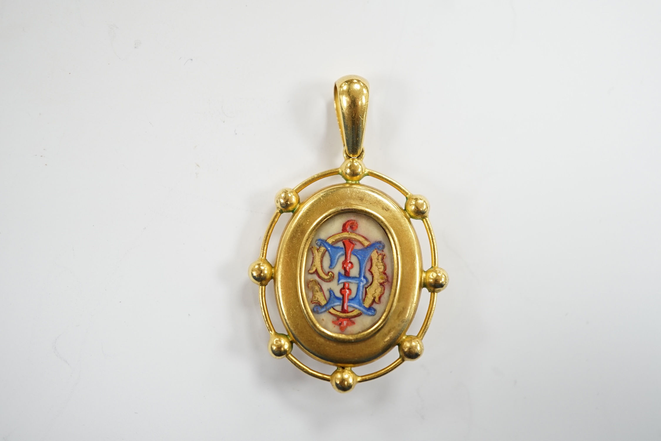 A Victorian yellow metal and split pearl set oval pendant, the glazed back with painted monogram beneath, EC, overall 48mm, gross weight 9.2 grams.